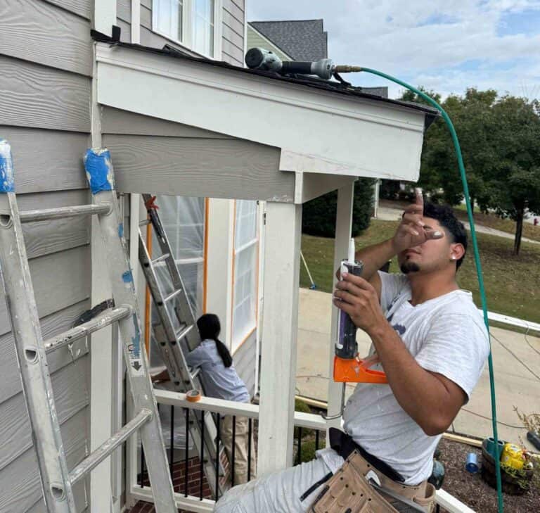 Gonzales Painters working on the exterior painting of a house.